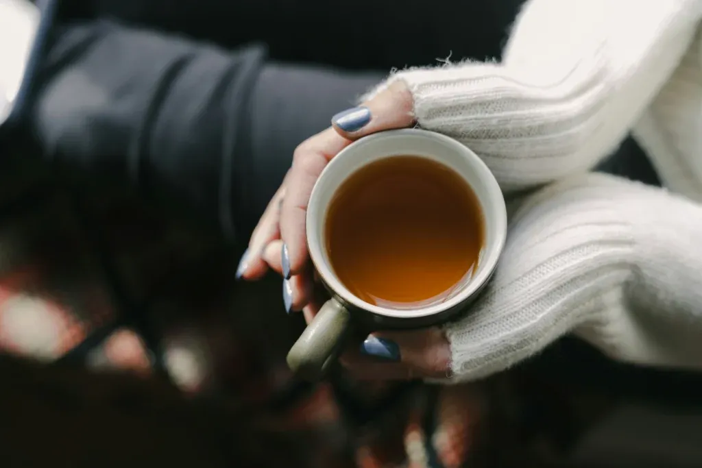 Hands holding a warm mug during a mindfulness break