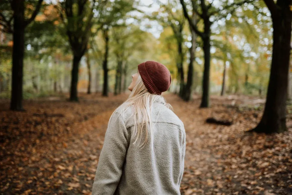 Person walking slowly through a forest while practicing mindfulness