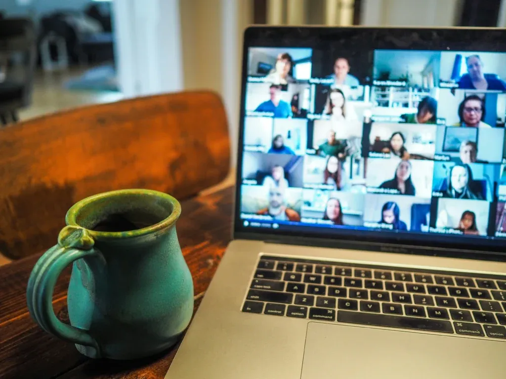 Young person on a video call with friends from their laptop